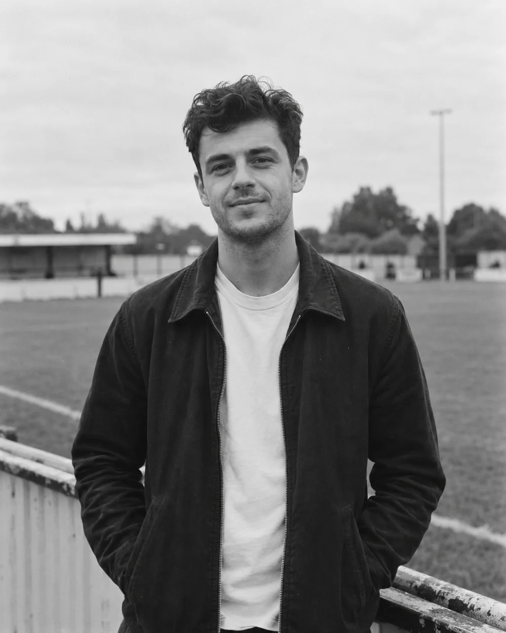 Sports journalist beside a football pitch